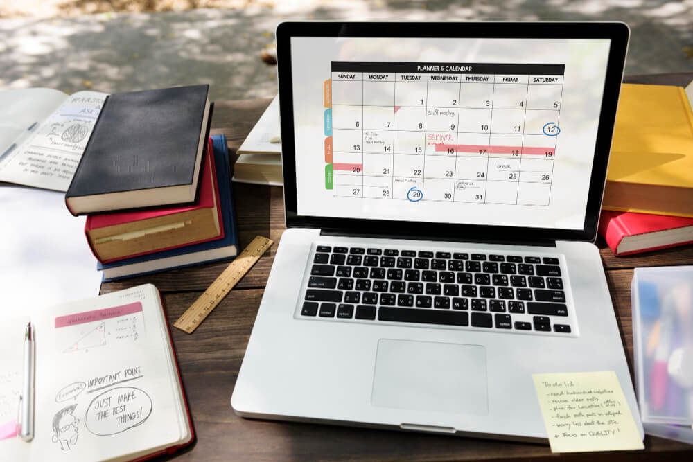 Notebook and calendar used to plan a fortnightly email schedule for a small business