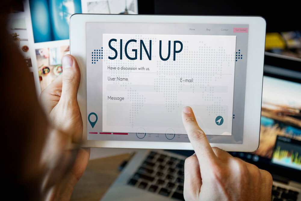 Customer completing a permission-based email signup form on a tablet