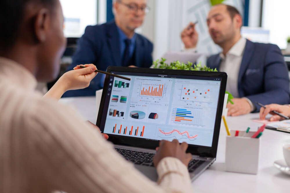 Small business team looking at email open and click metrics on a laptop screen