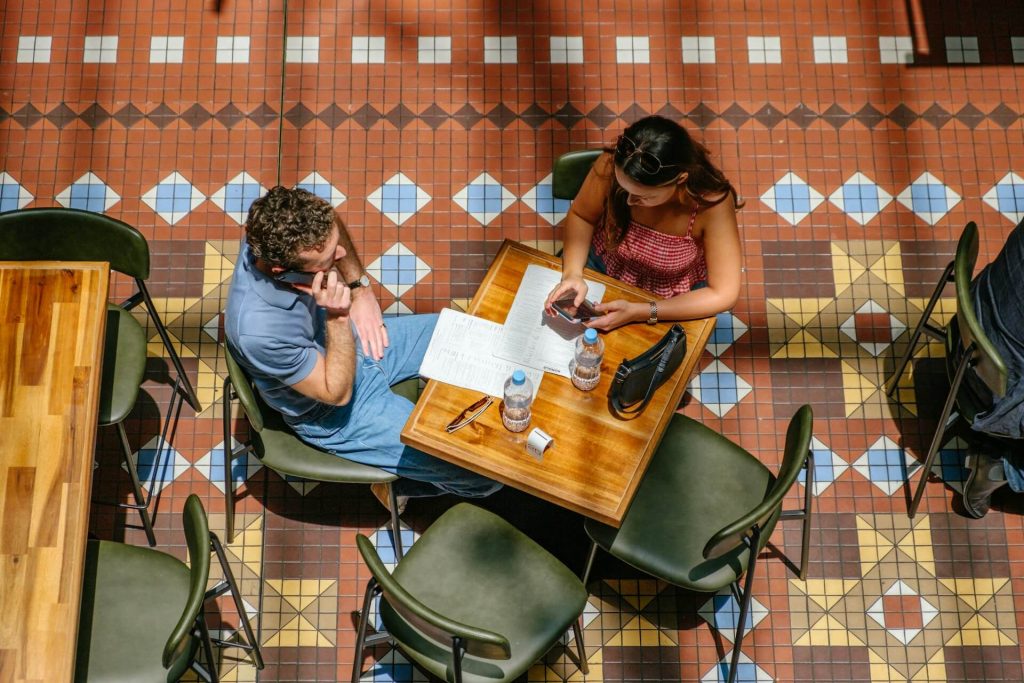 Business professional working on a laptop at an outdoor cafe table